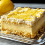 Lemon Cream Cheese Dump Cake 7 Lemon Cream Cheese Dump Cake served on a plate with fresh lemon slices